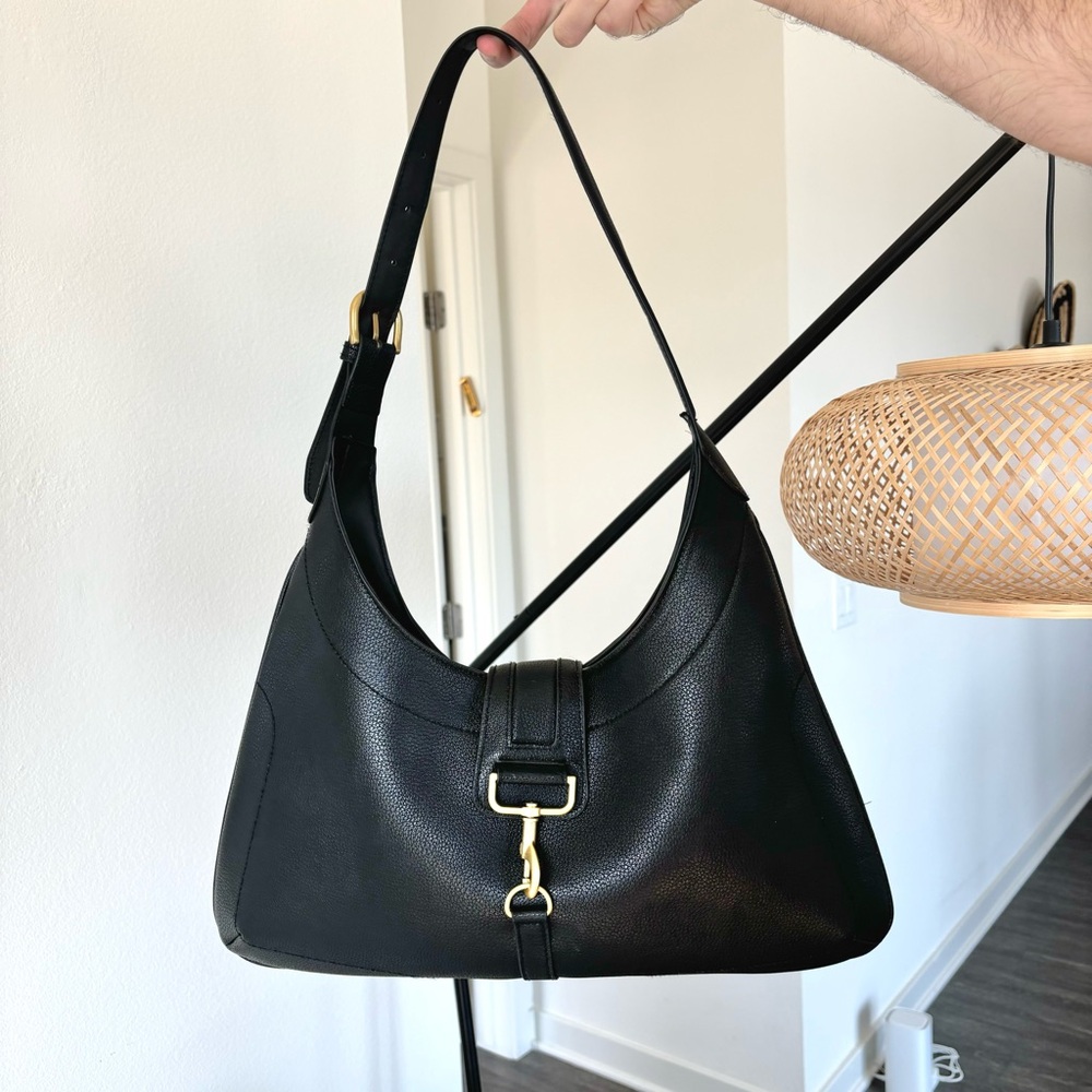 Black shoulder bag with flap and gold buckle